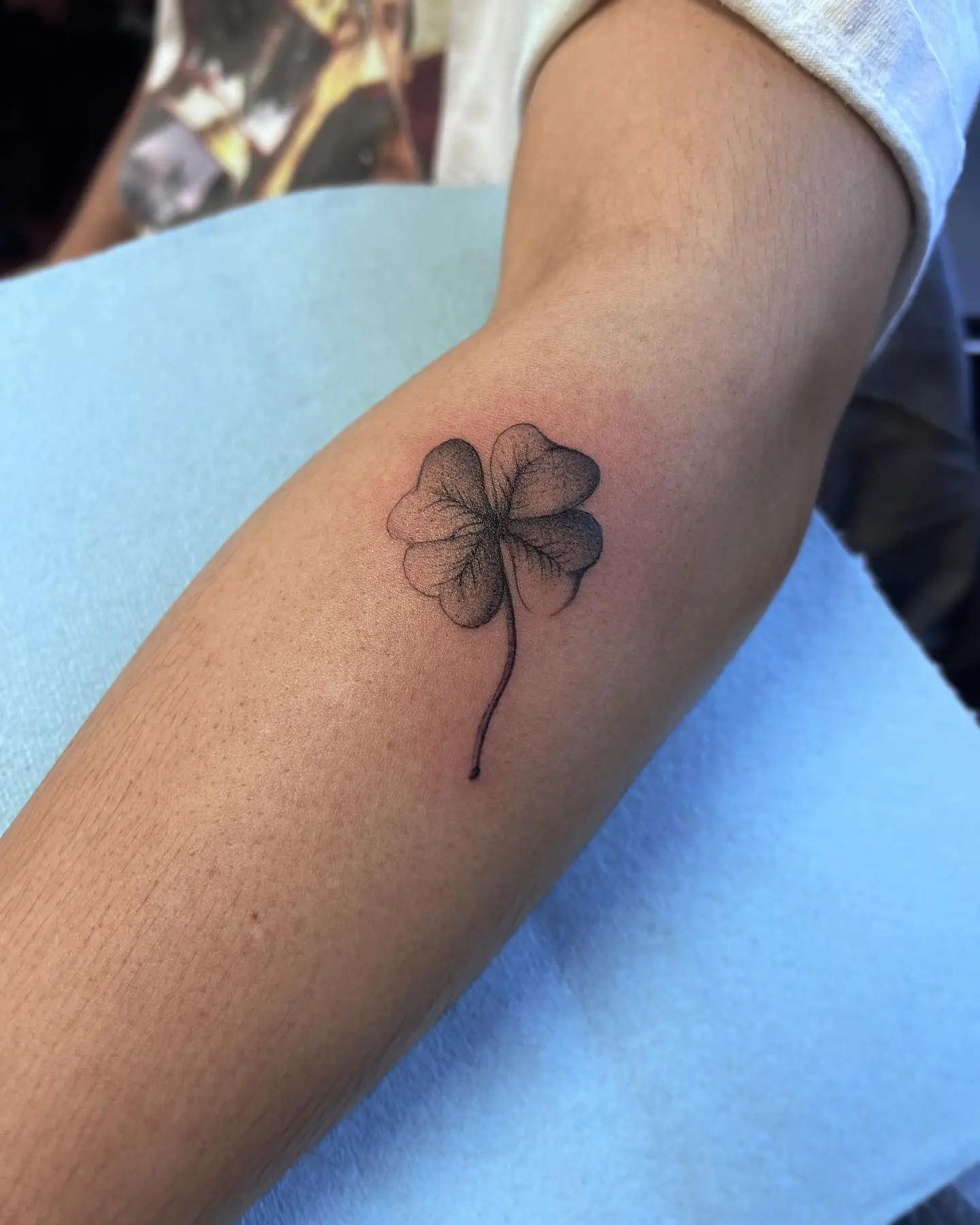 Elegant black and gray four-leaf clover tattoo