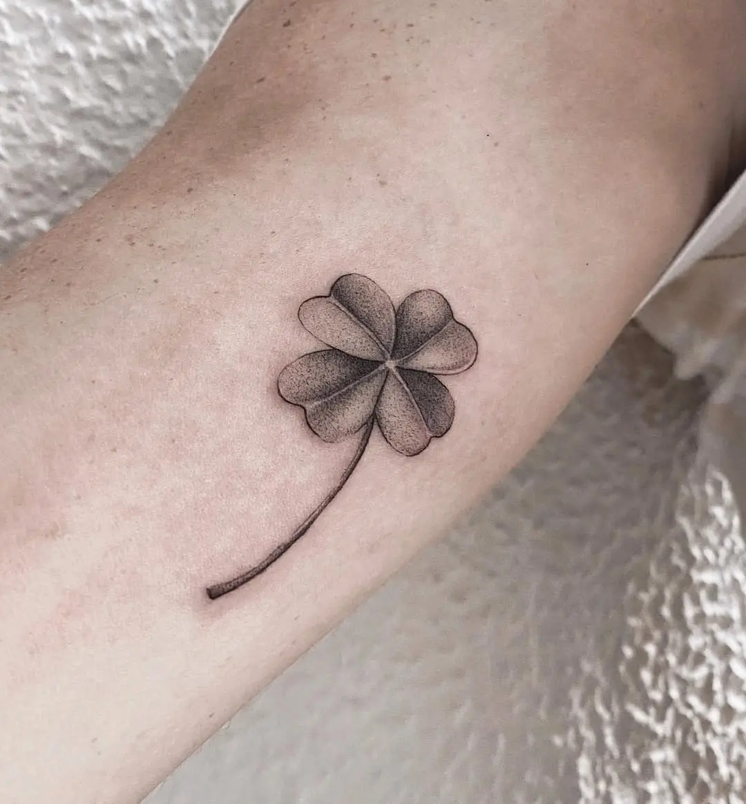 Elegant four leaf clover tattoo with soft shading