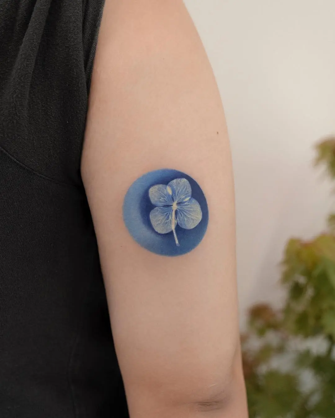 Stunning blue four-leaf clover tattoo design