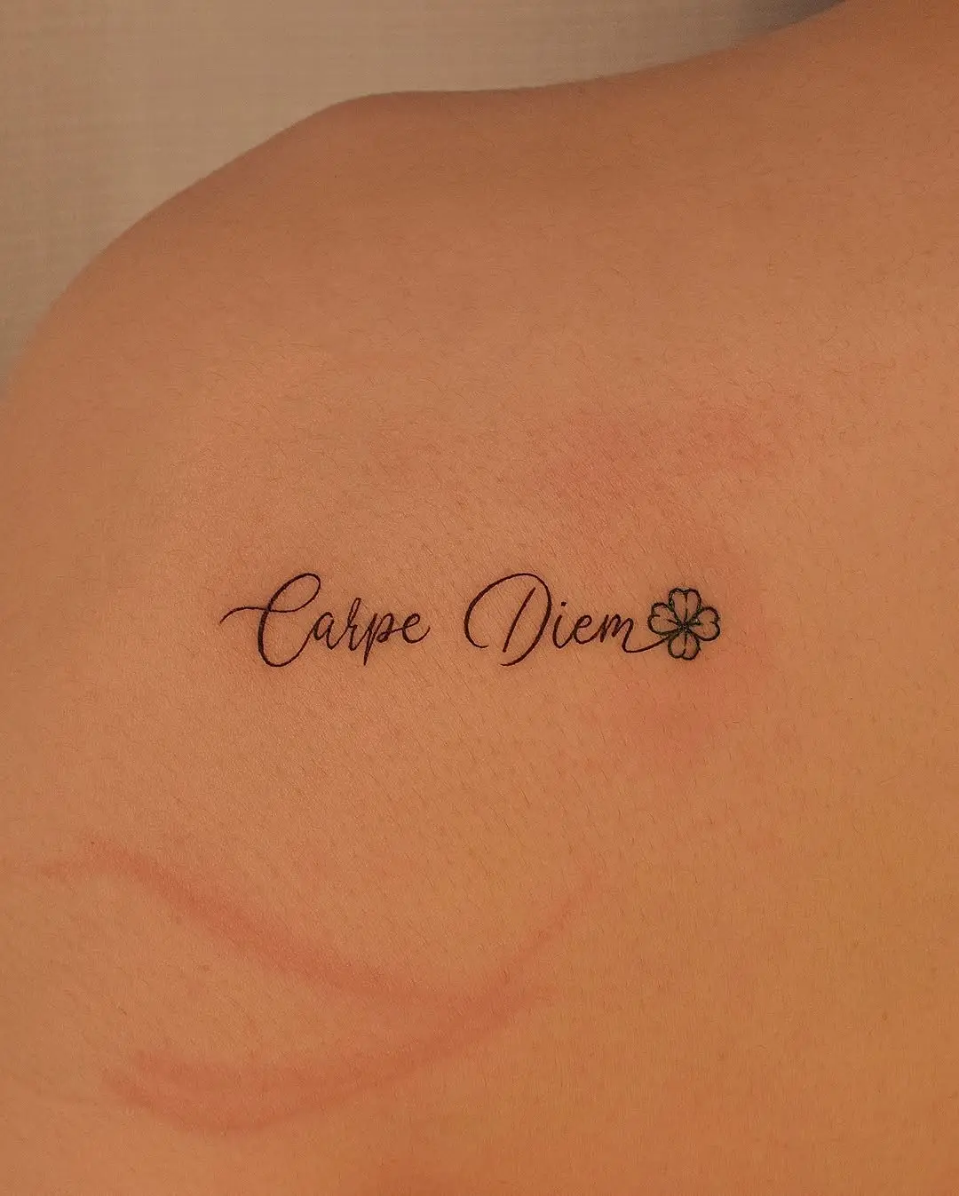 Elegant four leaf clover tattoo with phrase