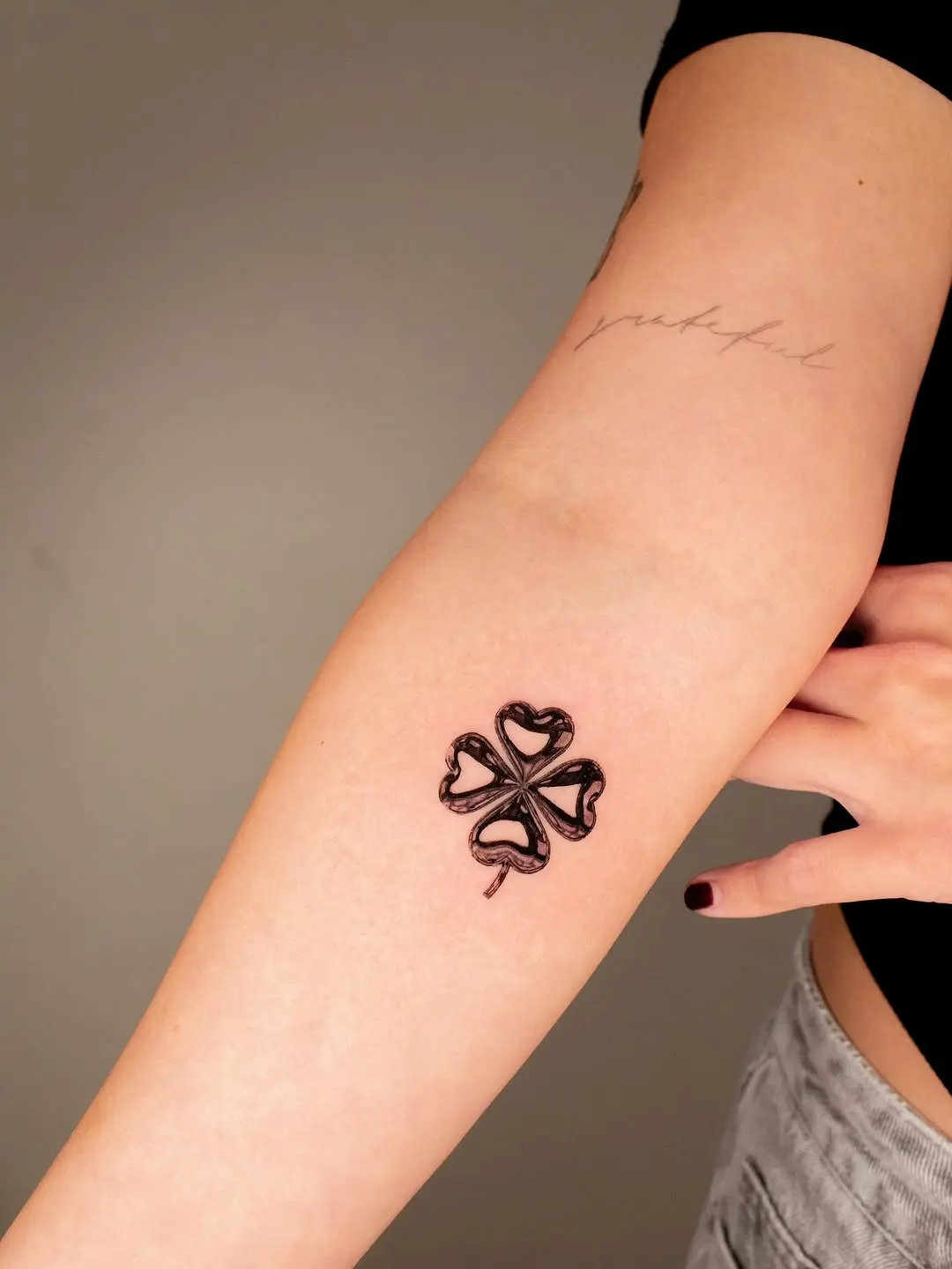 Elegant design showcasing a four-leaf clover tattoo