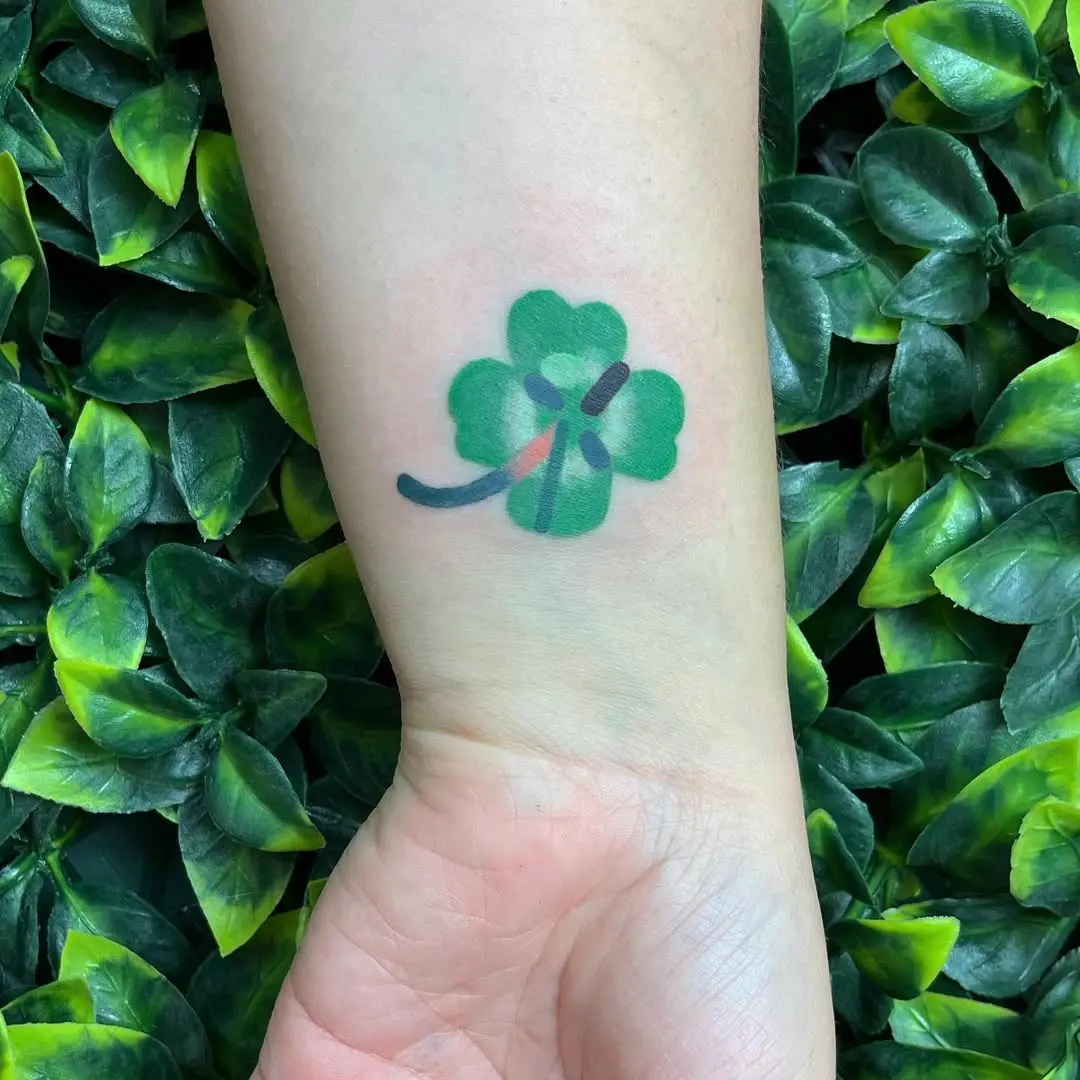 Charming green four leaf clover tattoo design