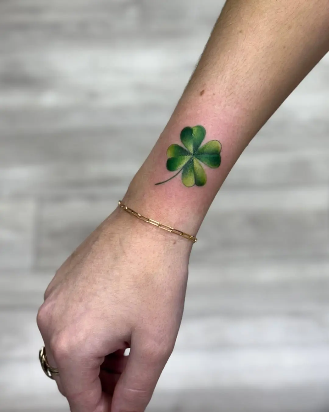 Elegant four-leaf clover tattoo on wrist
