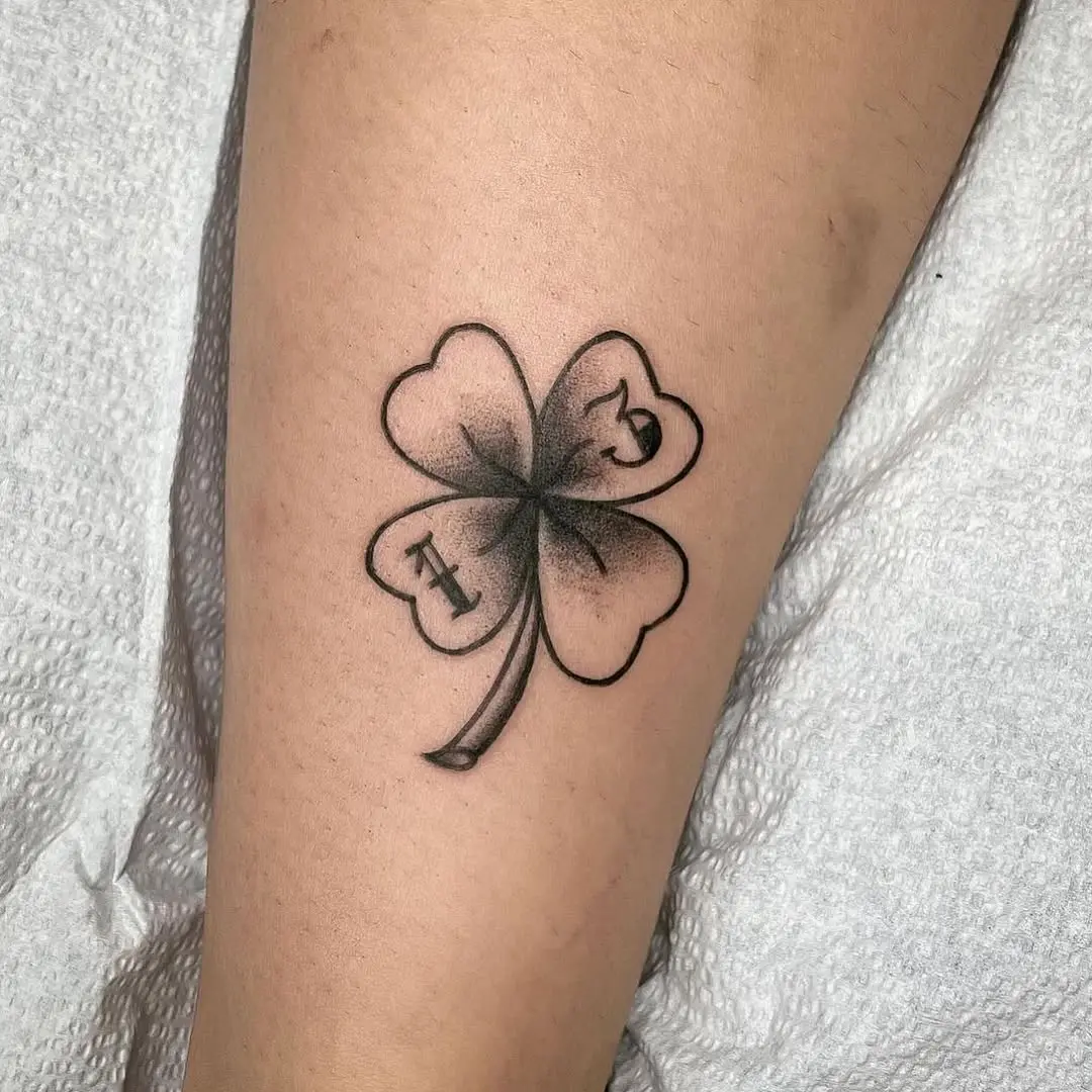 Elegant four-leaf clover tattoo on skin