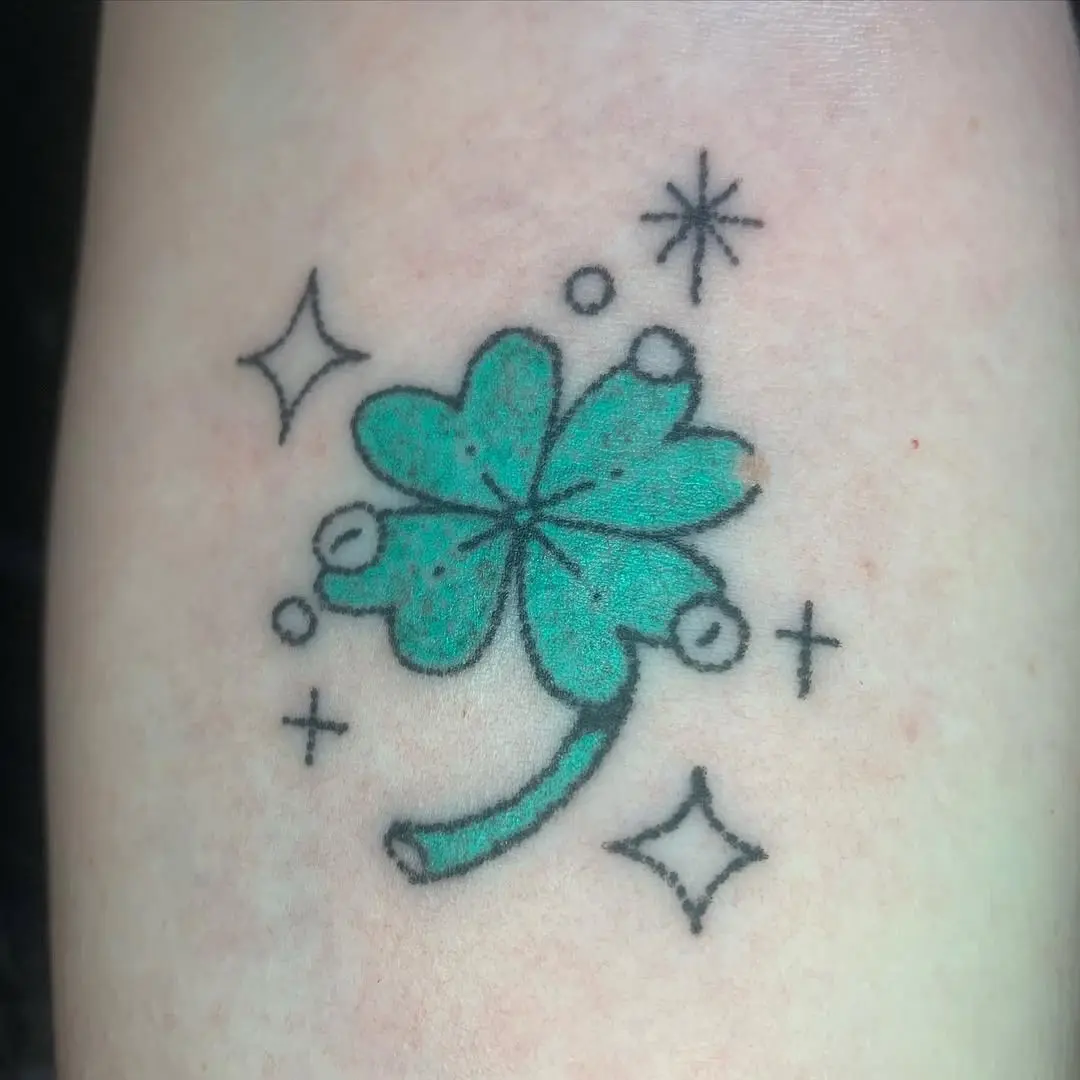 Charming four-leaf clover tattoo with sparkles