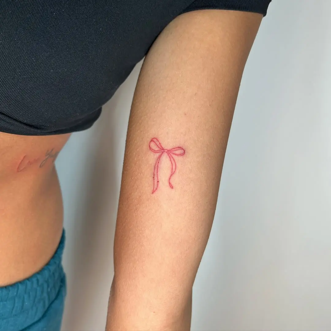 Charming Red Bow Tattoo Design on Arm
