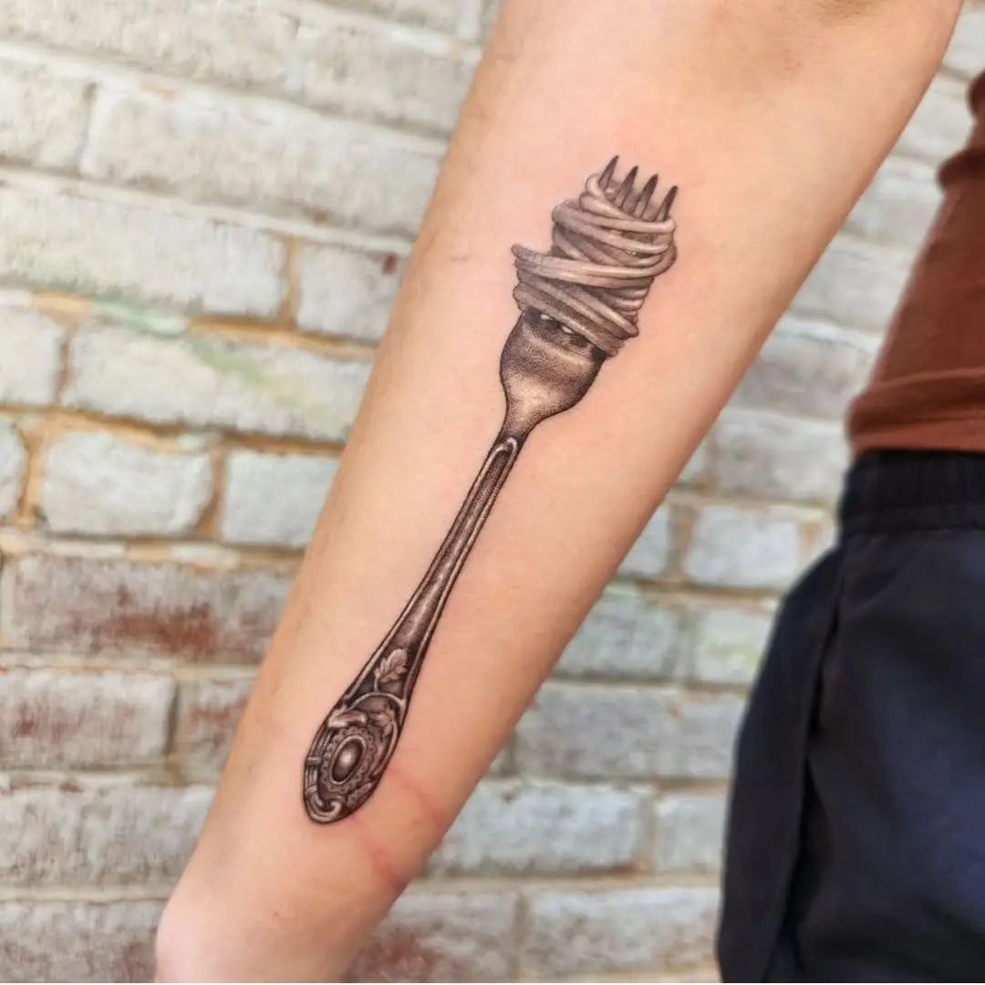 A creative fork tattoo design with noodles
