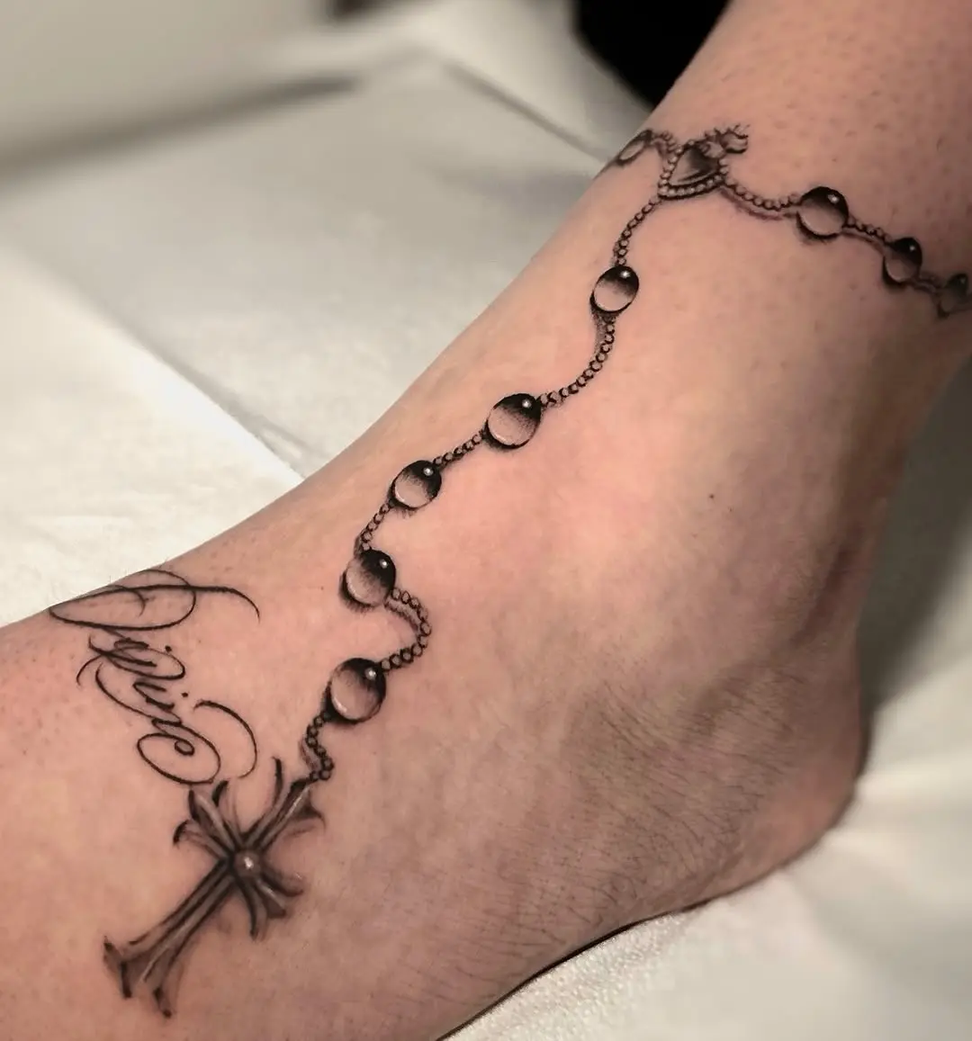 Elegant rosary tattoo adorning the ankle.