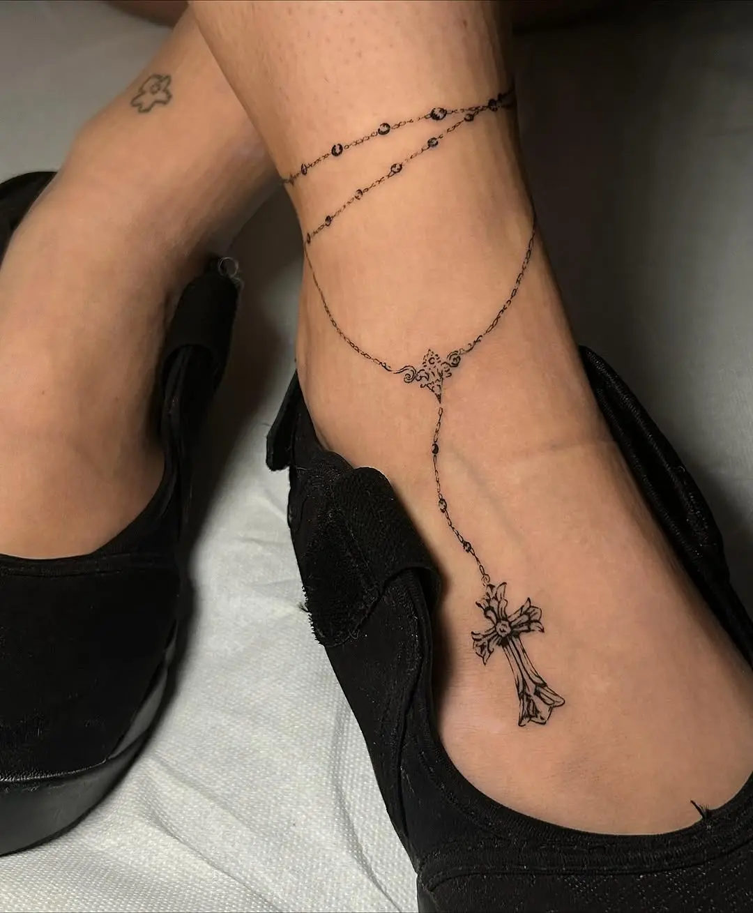 Elegant ankle rosary tattoo with cross charm