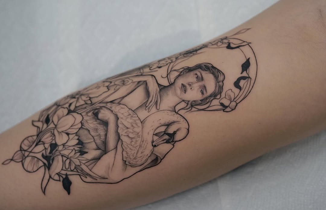 Elegant art nouveau tattoo featuring swan and figure