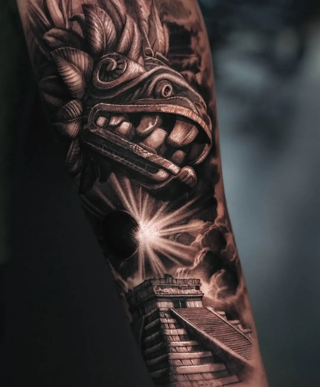 Intricate Aztec dragon tattoo on forearm