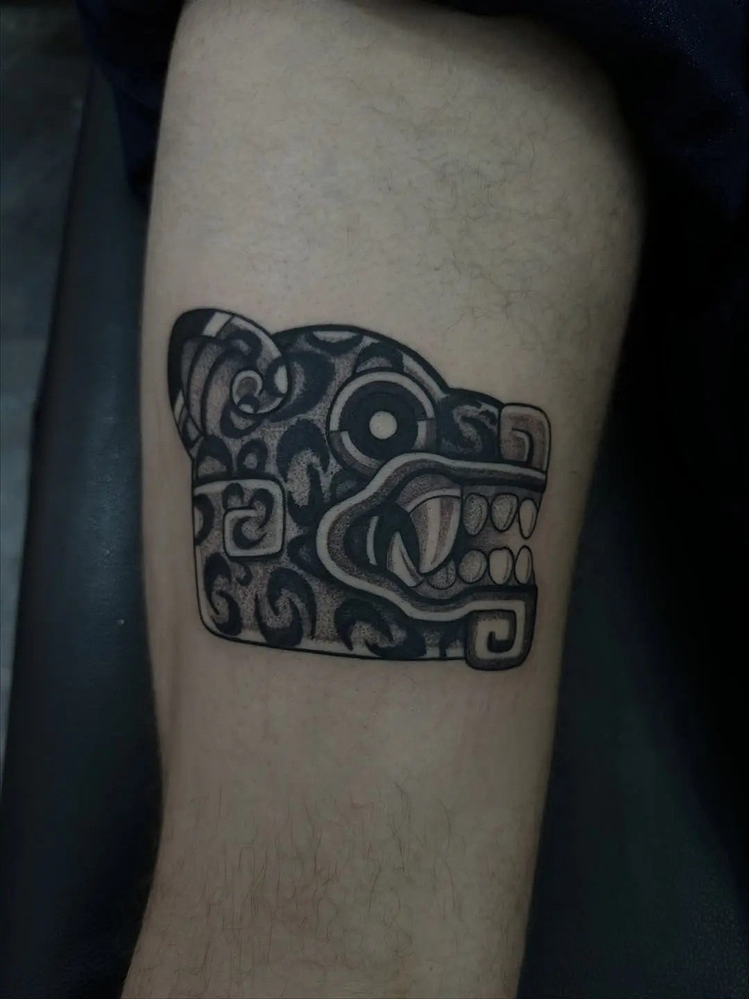 Intricate jaguar head tattoo in black ink