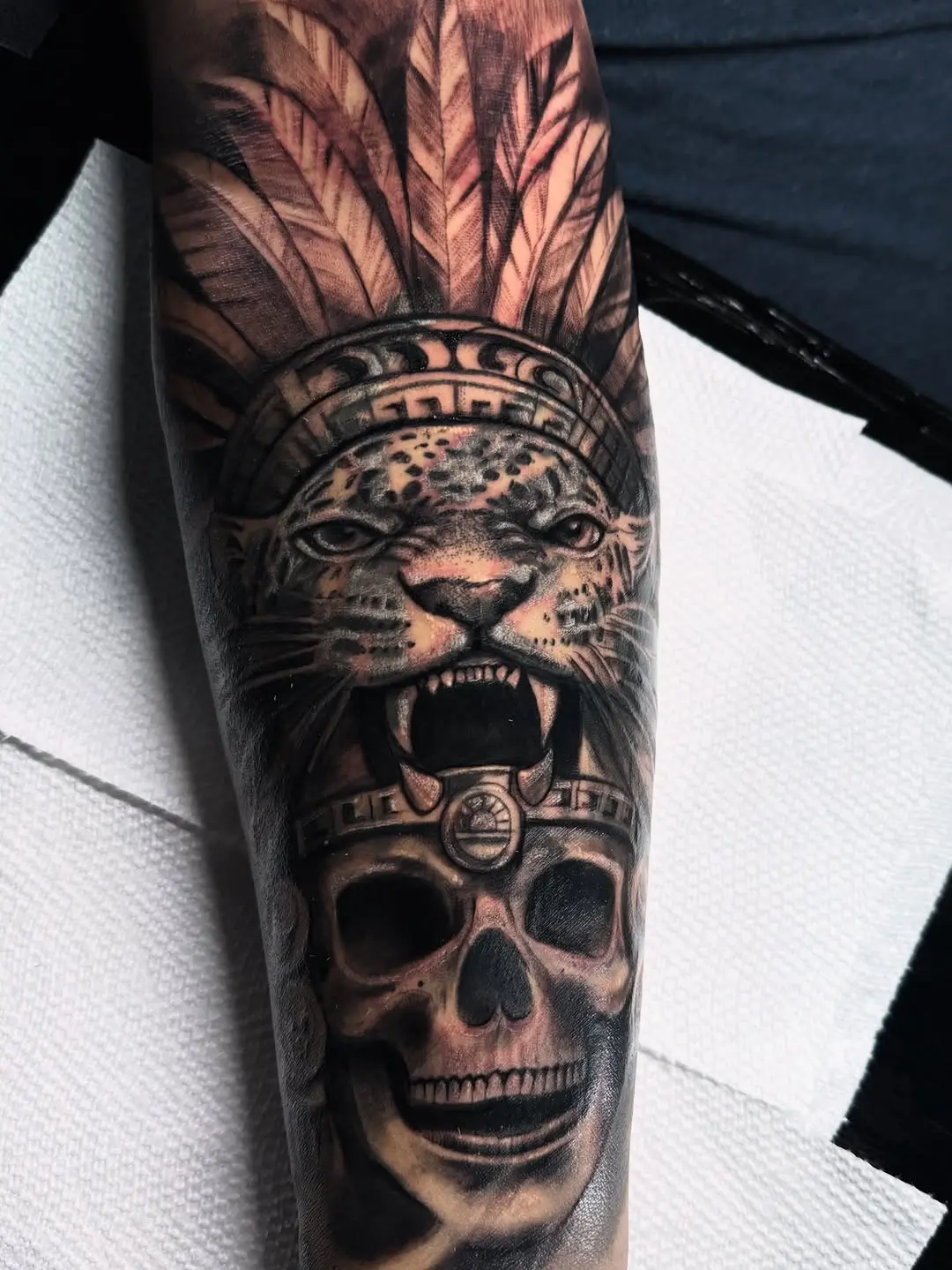 Powerful Aztec-inspired skull and jaguar tattoo