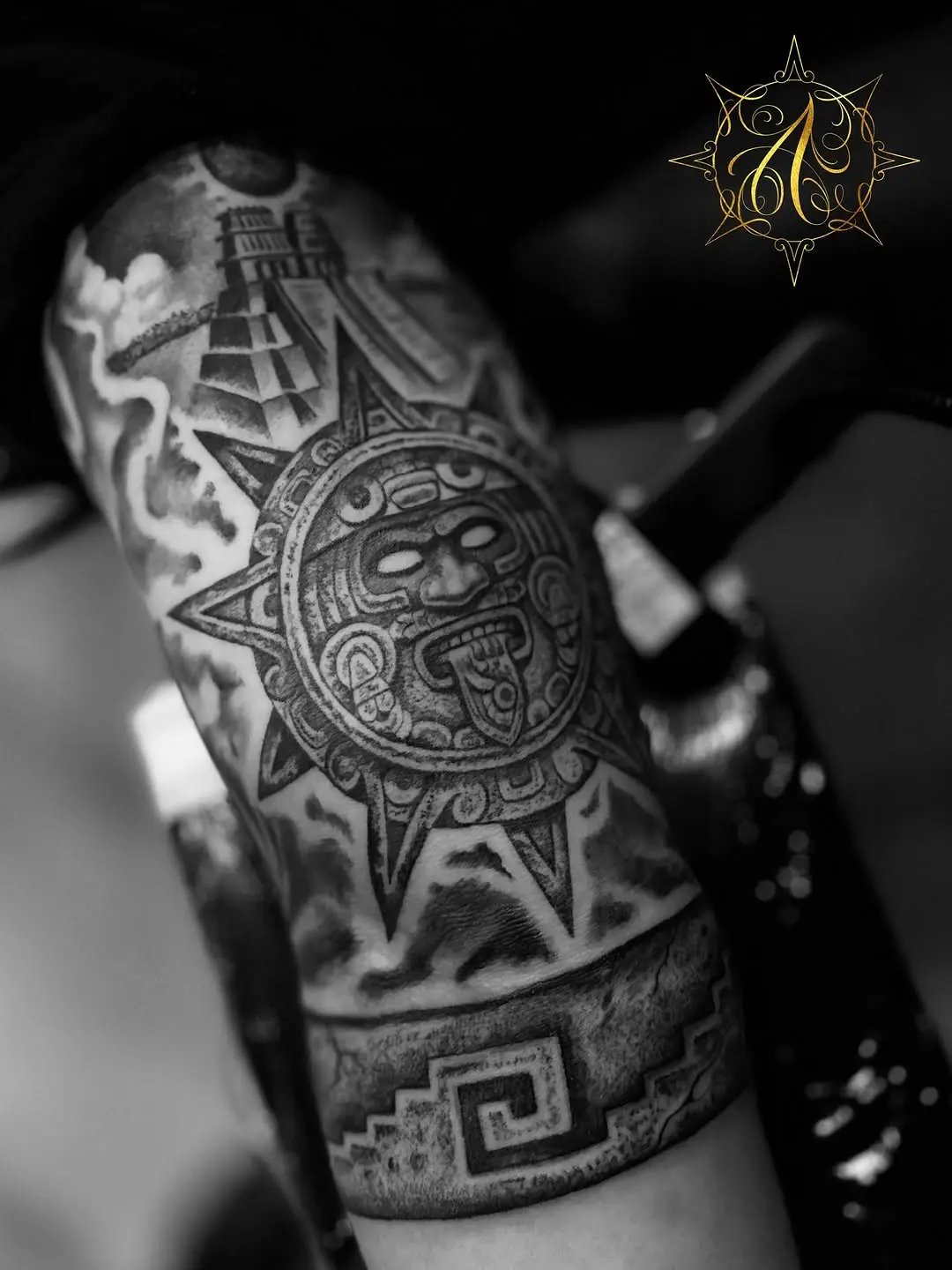Intricate Aztec sun tattoo with geometric patterns