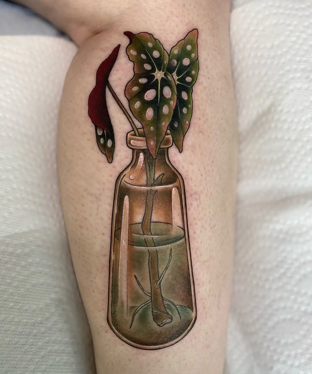 Elegant begonia tattoo in glass bottle