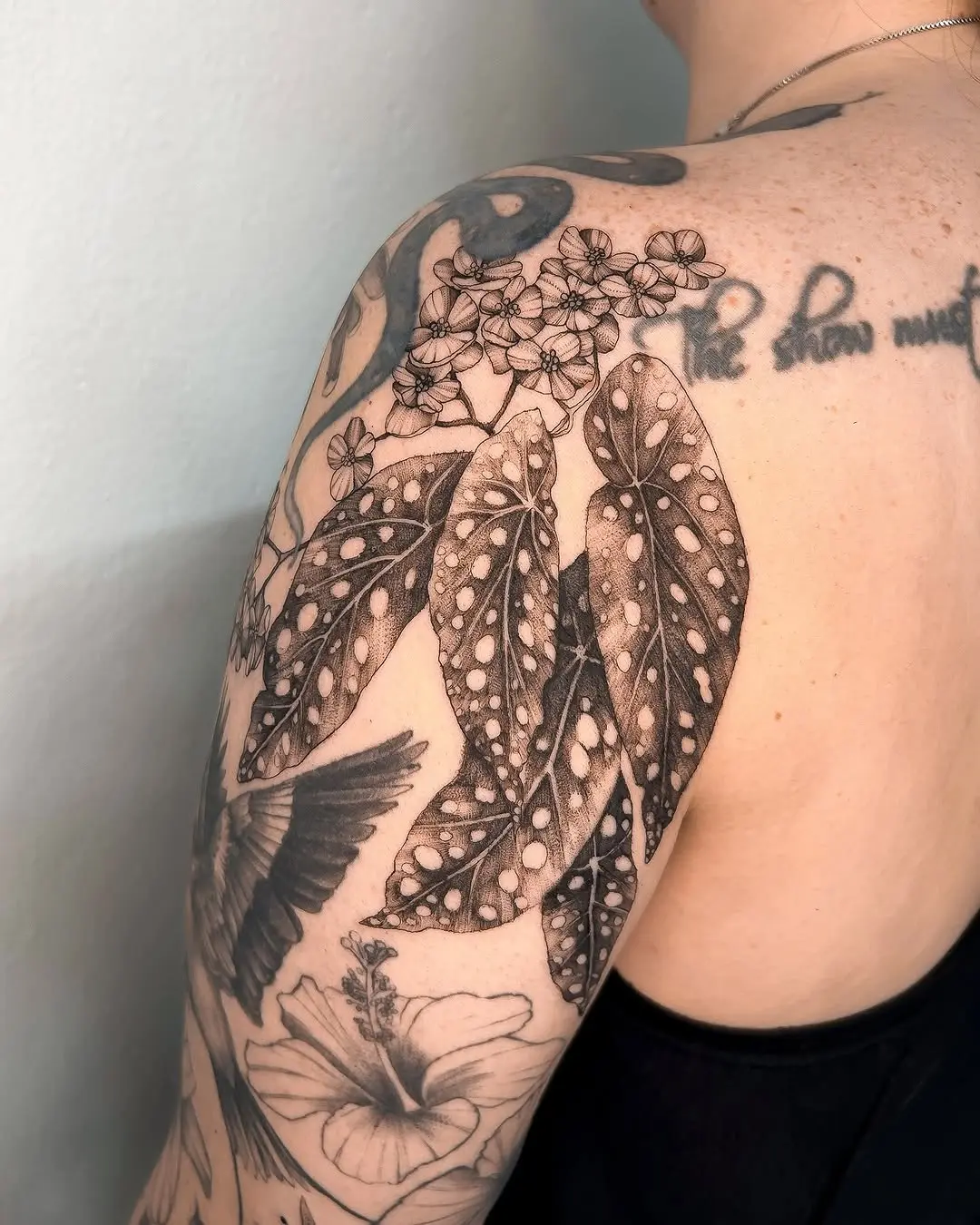 Elegant begonia tattoo with detailed leaves and blooms