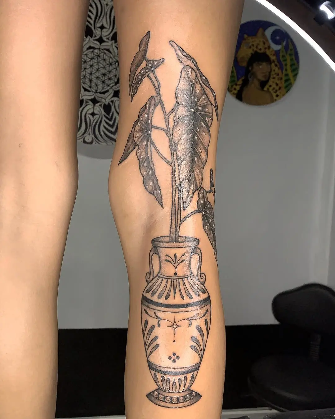 Elegant begonia tattoo in a decorative vase