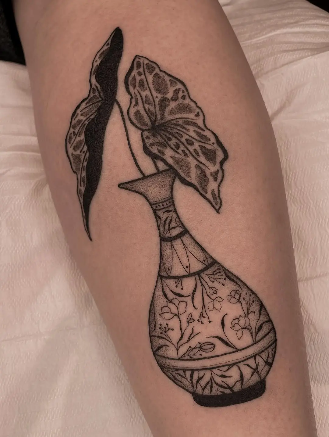 Elegant begonia design in a vase tattoo