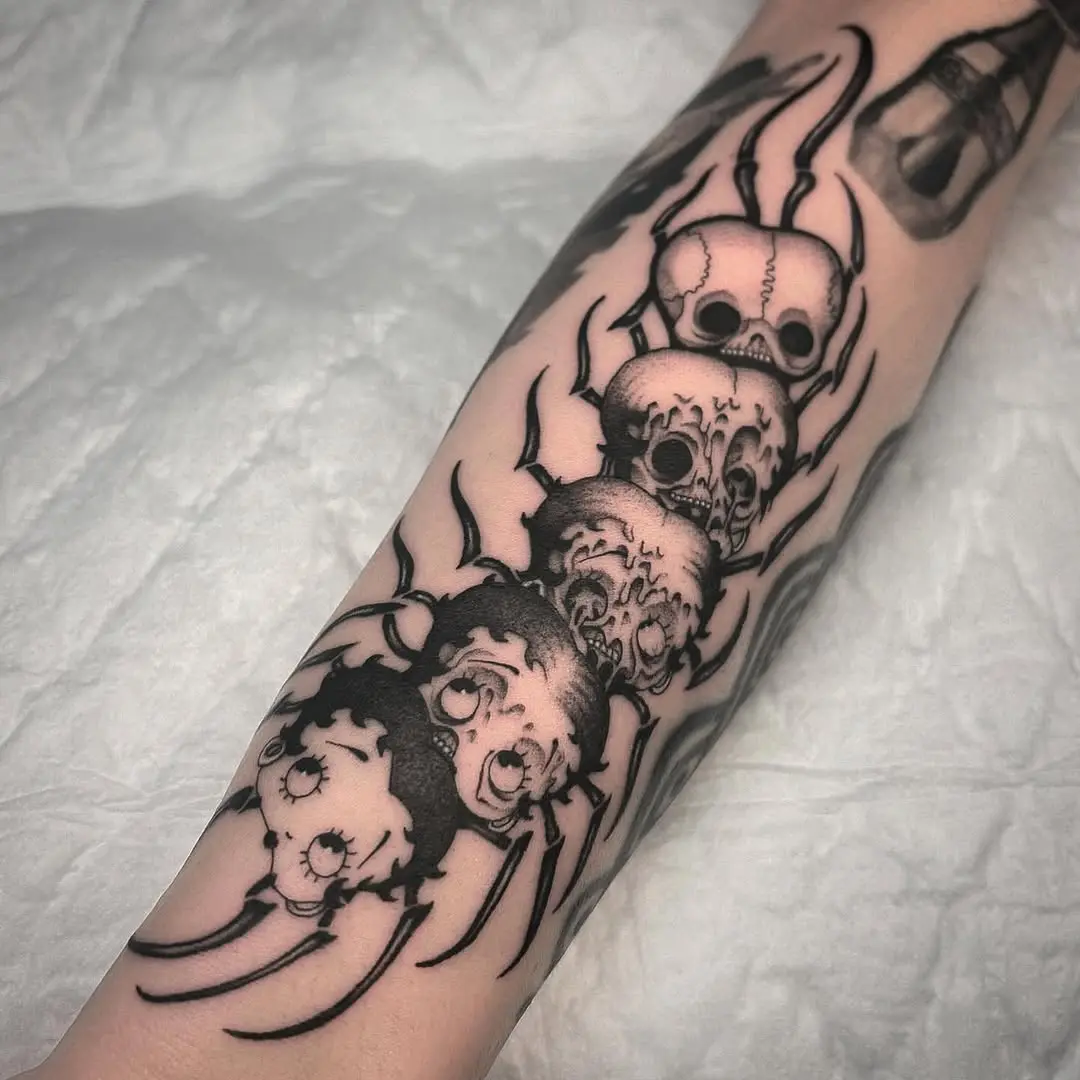 Intricate black ink spider skull tattoos