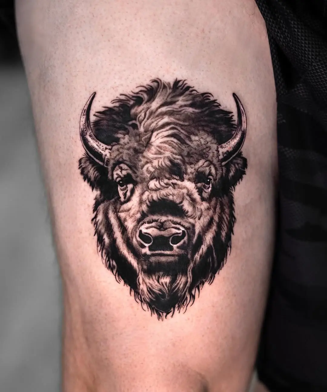 Detailed bison head tattoo showcasing realism