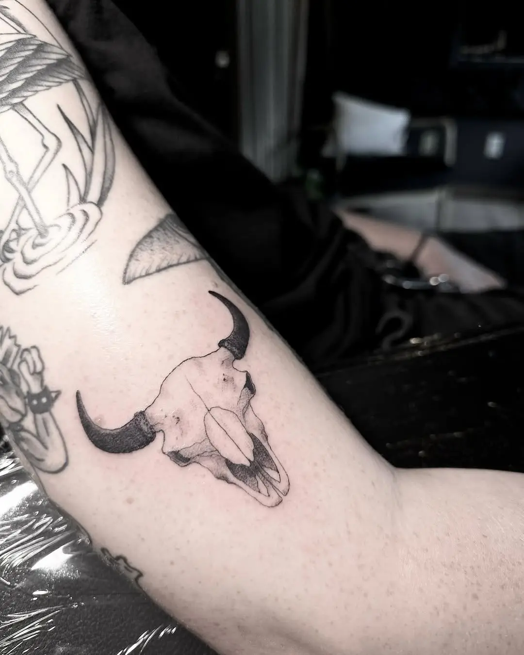 Minimalist bison skull tattoo on the arm
