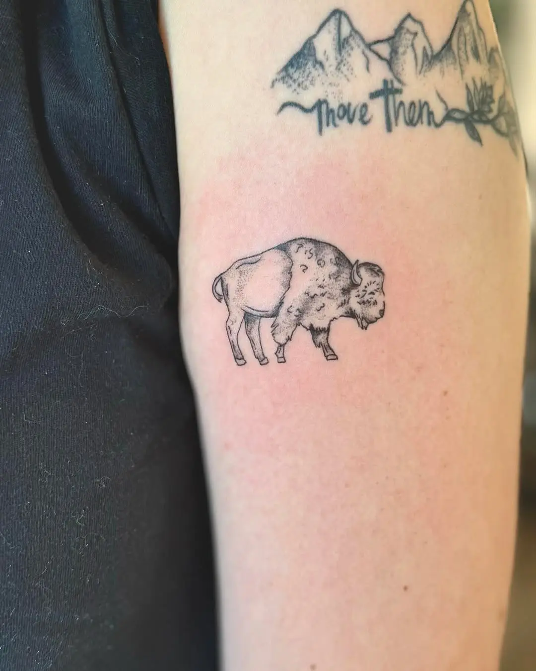 Artistic black ink bison tattoo on arm