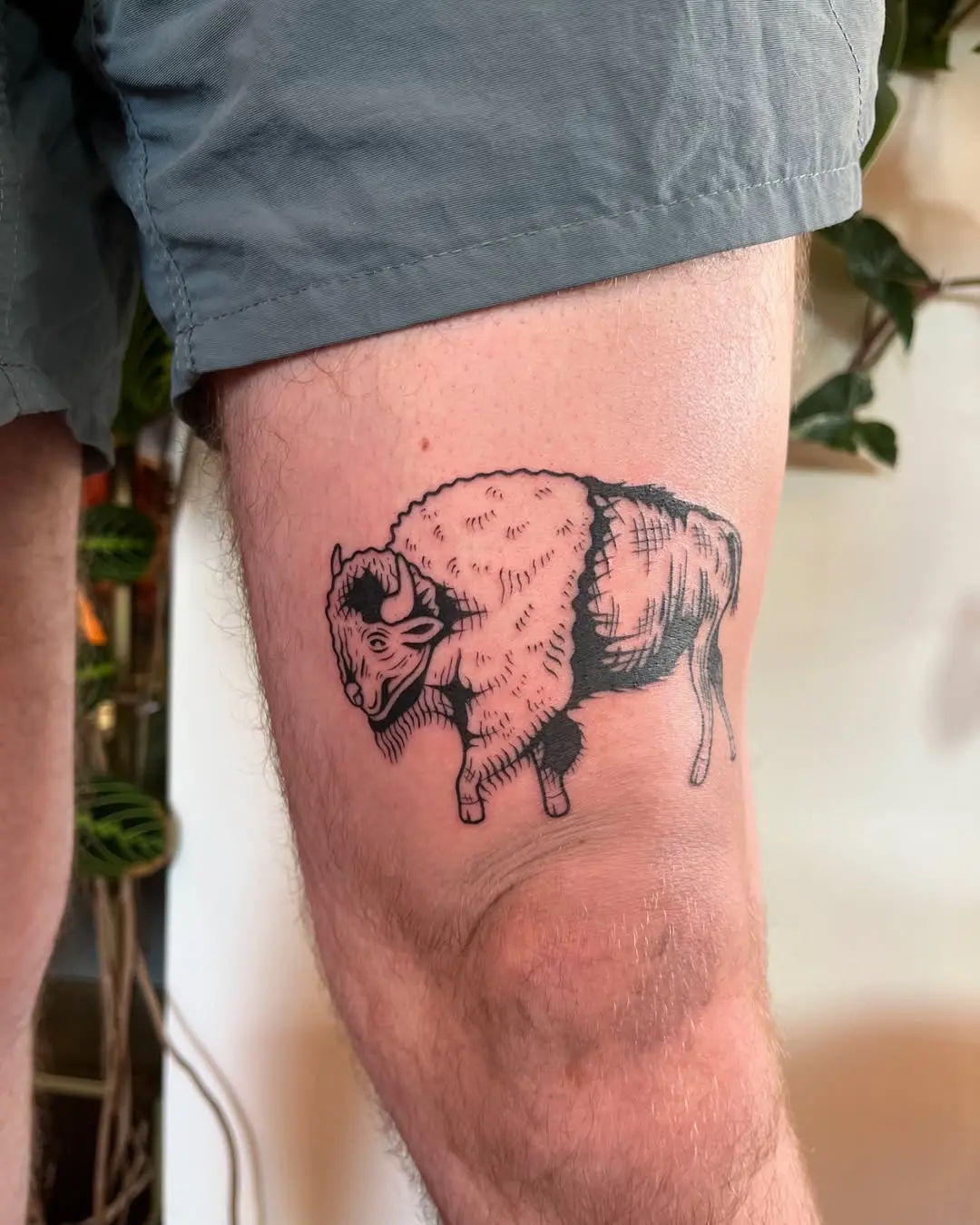Vintage-inspired bison tattoo on thigh