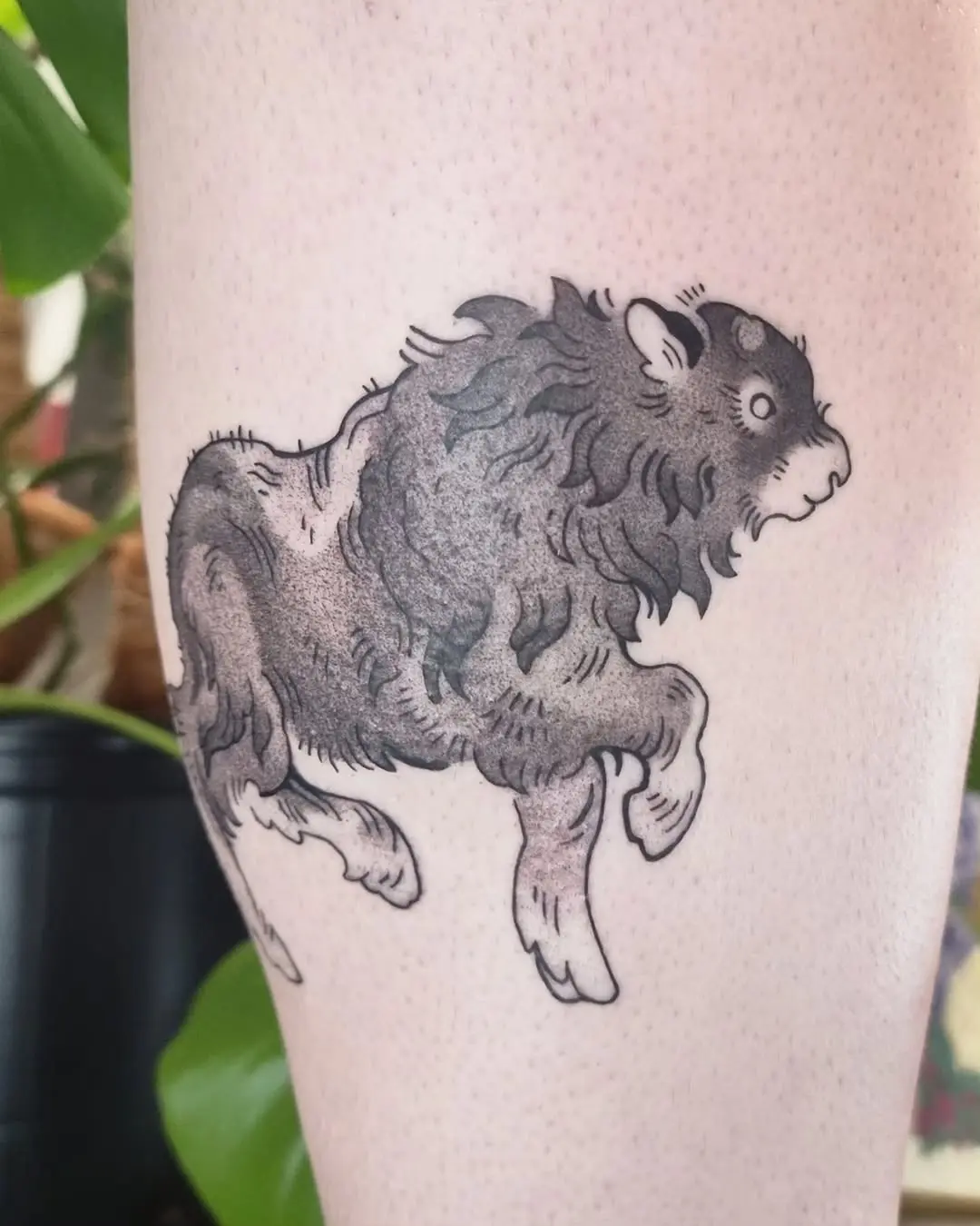 Dynamic bison tattoo in striking black ink