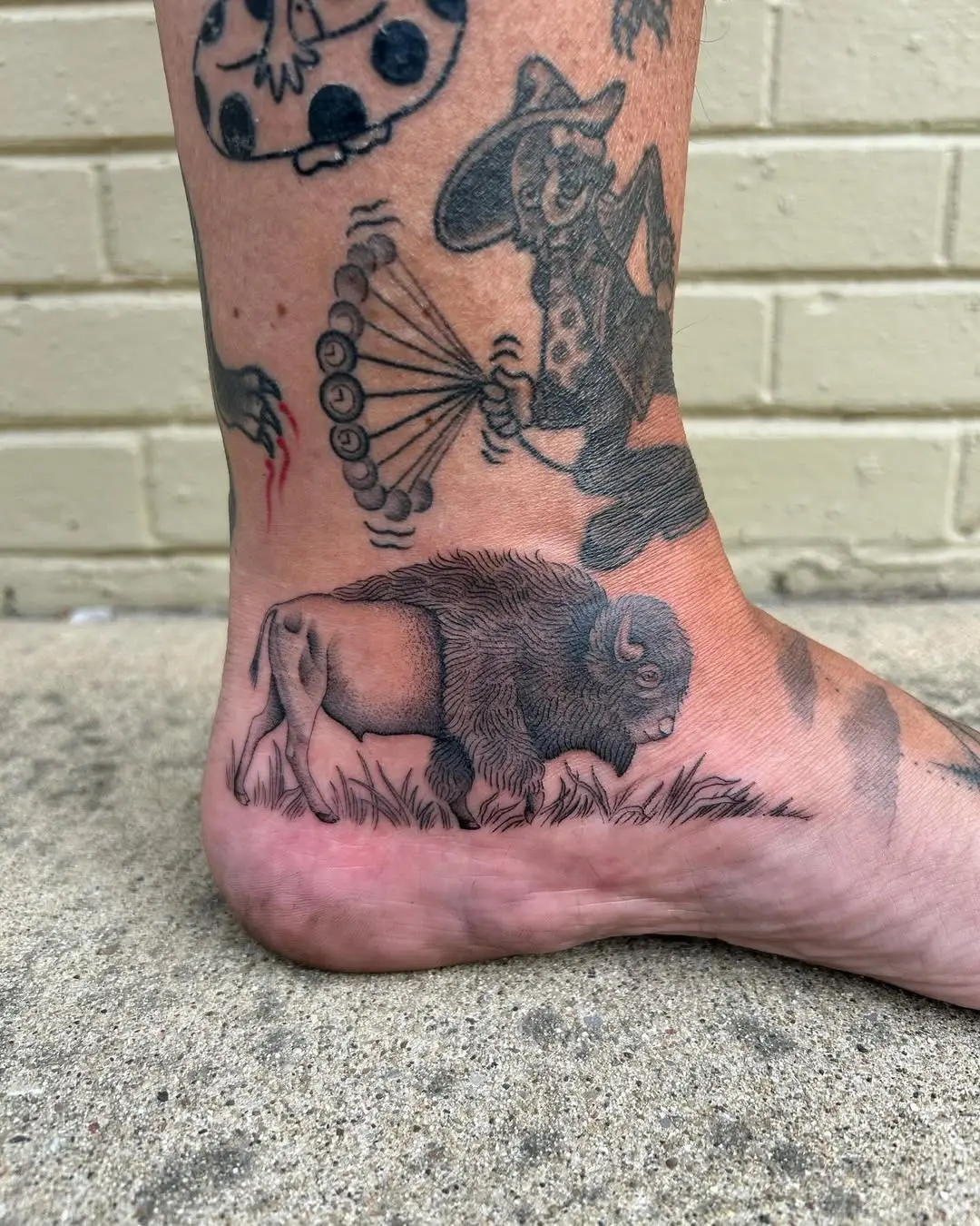 Elegant bison tattoo on the ankle area