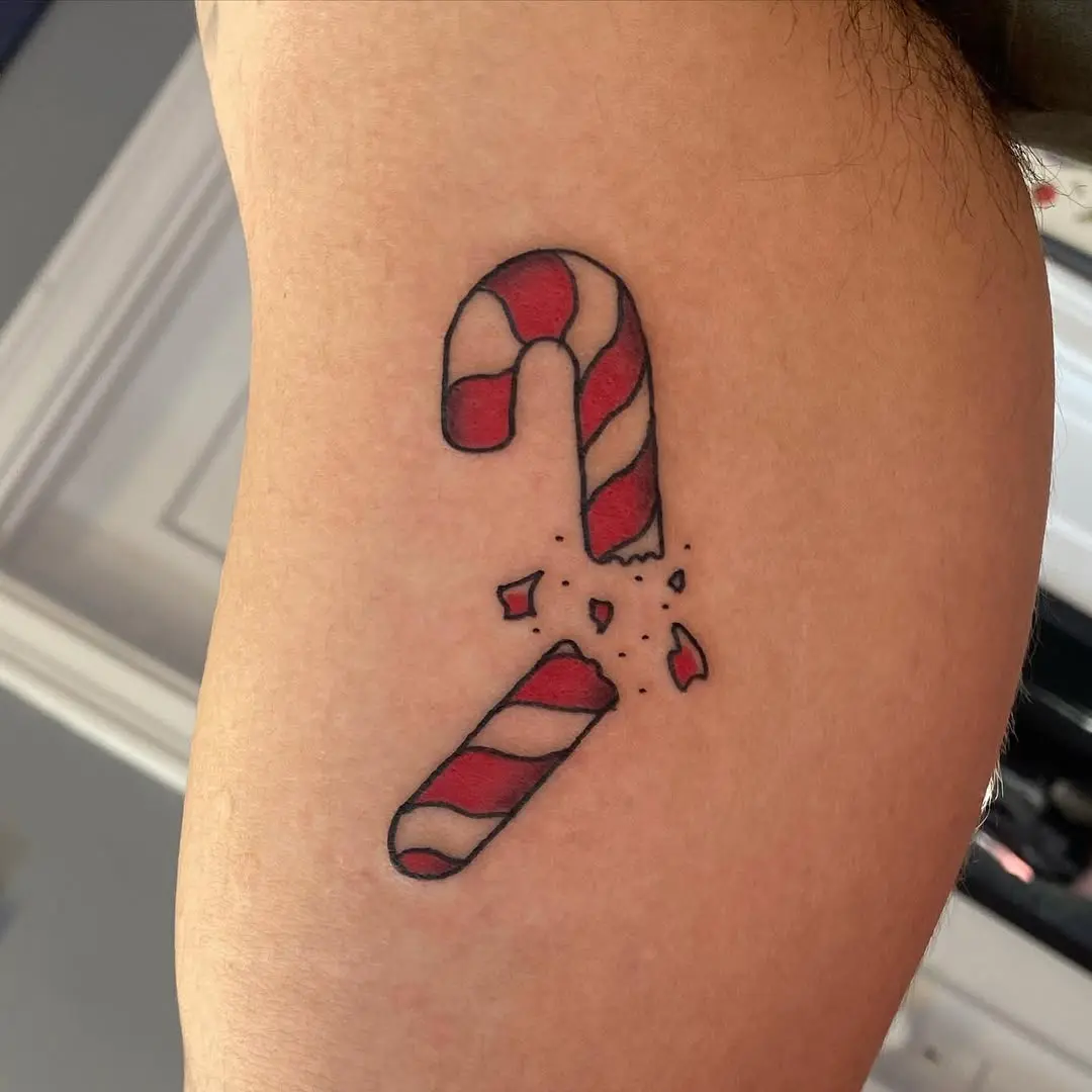 Playful broken candy cane tattoo design