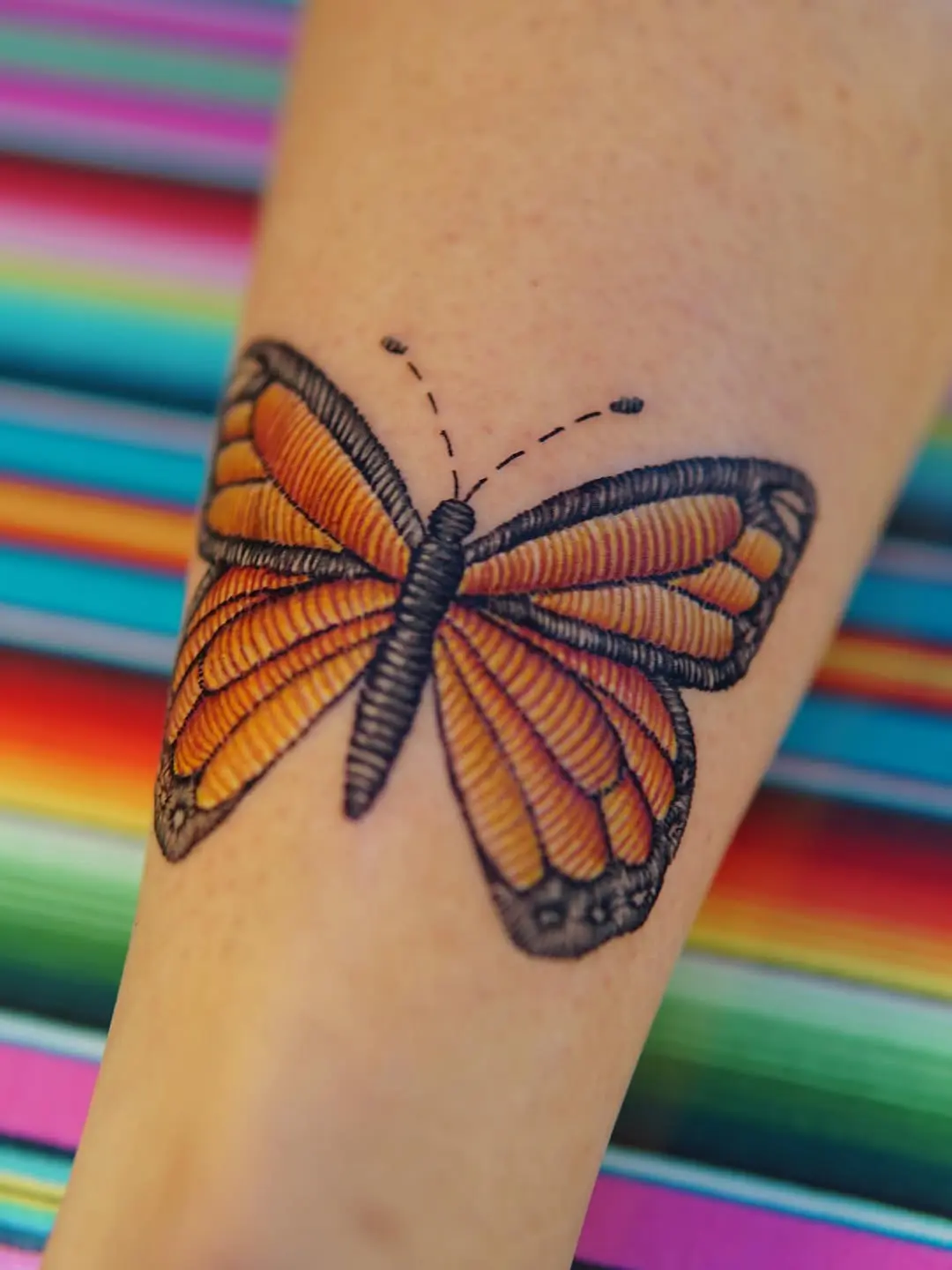 Stunning embroidery-style butterfly tattoo on skin