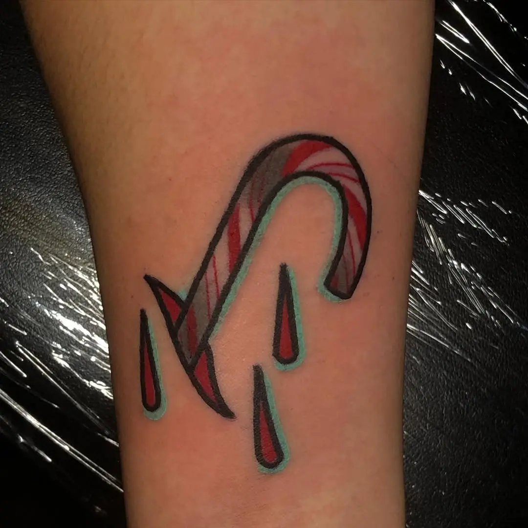 Bold candy cane tattoo with striking red drips