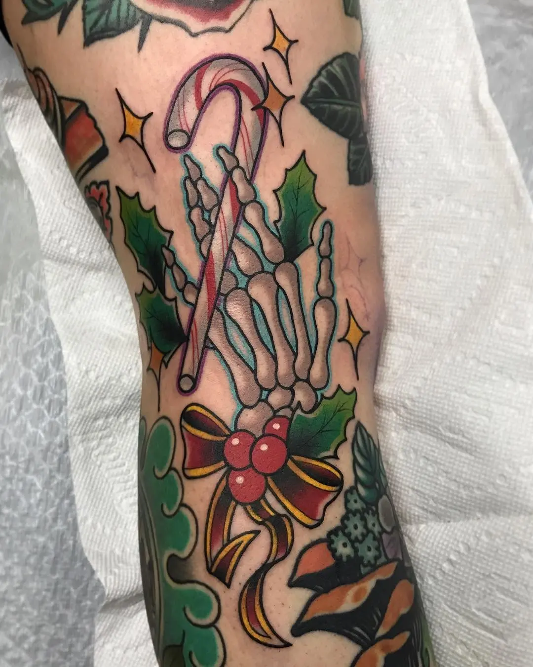 Whimsical candy cane skeleton tattoo design