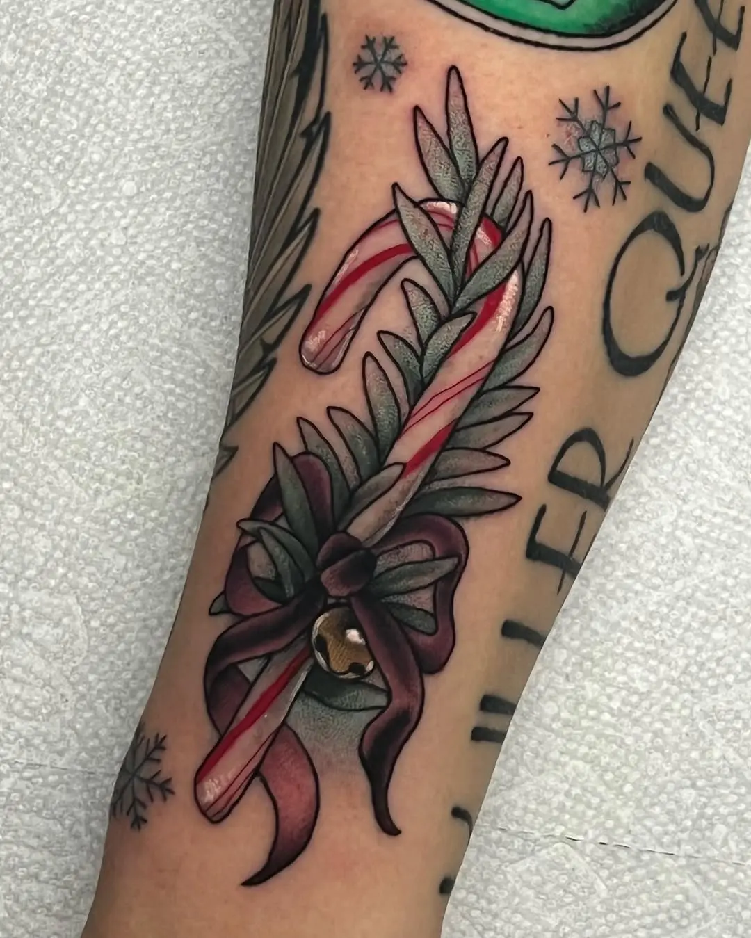 Charming candy cane tattoo with festive elements