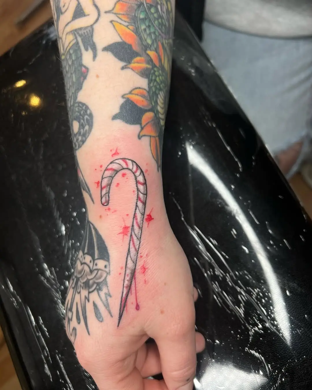 Stylish Candy Cane Tattoo with Sparkling Details