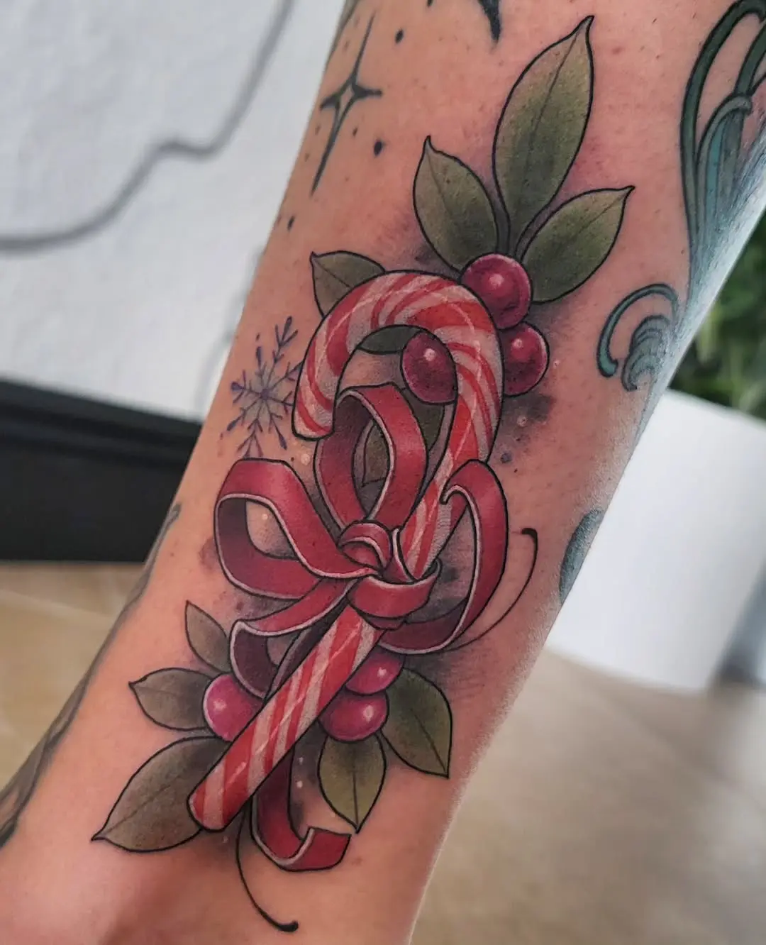 Colorful candy cane tattoo with festive elements