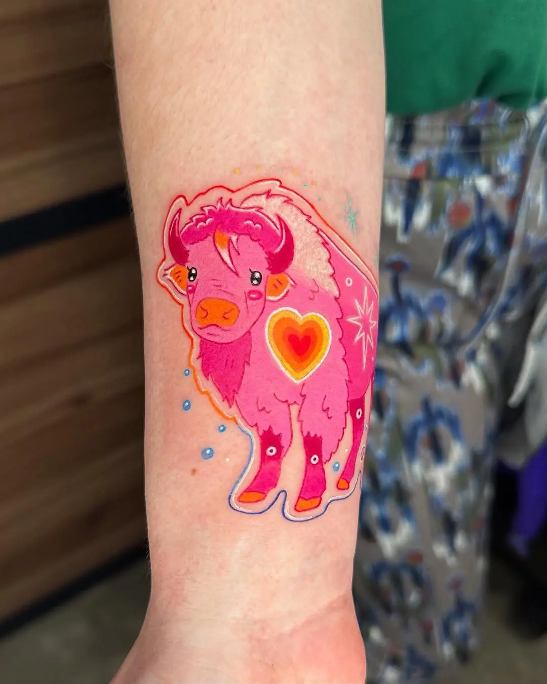 Vibrant bison tattoo infused with heart motifs