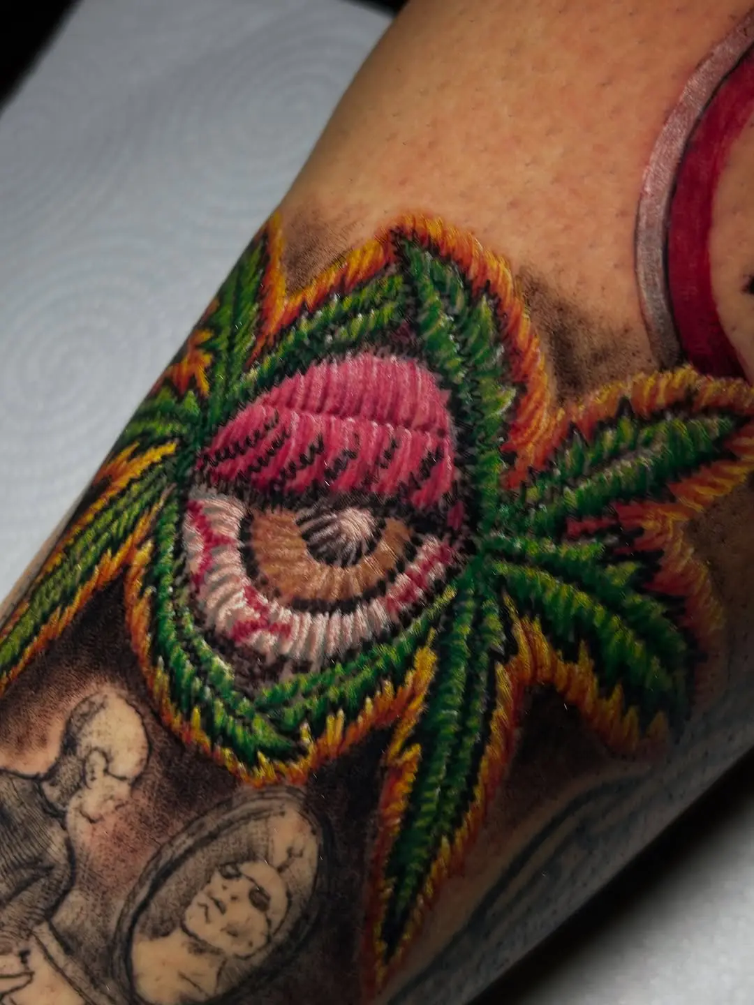 Unique embroidery-style eye and leaf tattoo