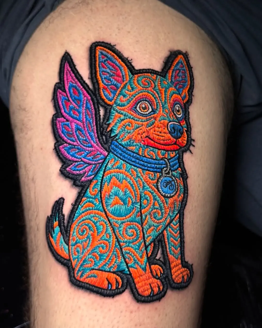 Vibrant embroidered canine with magical wings.