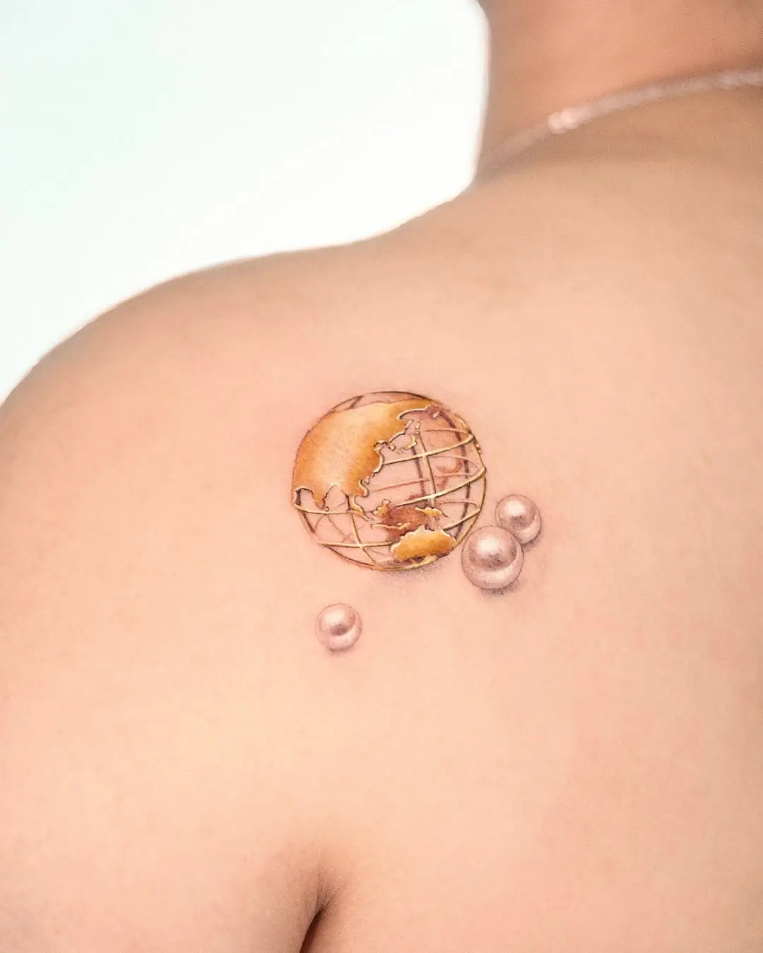 Stunning globe tattoo with elegant details