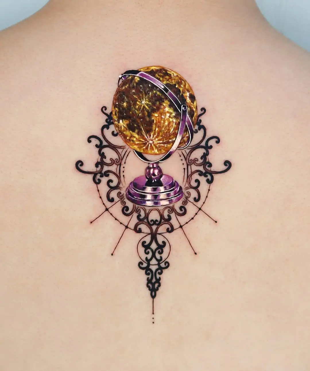 Elegant globe tattoo with intricate design elements