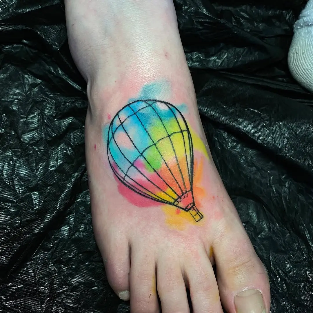 Colorful hot air balloon tattoo on the foot