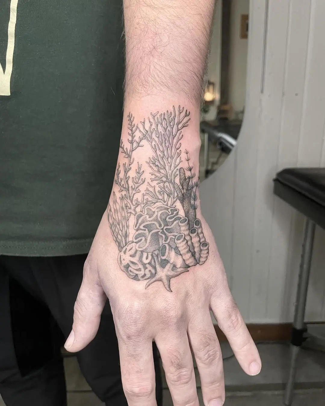 Intricate coral designs on the hand tattoo