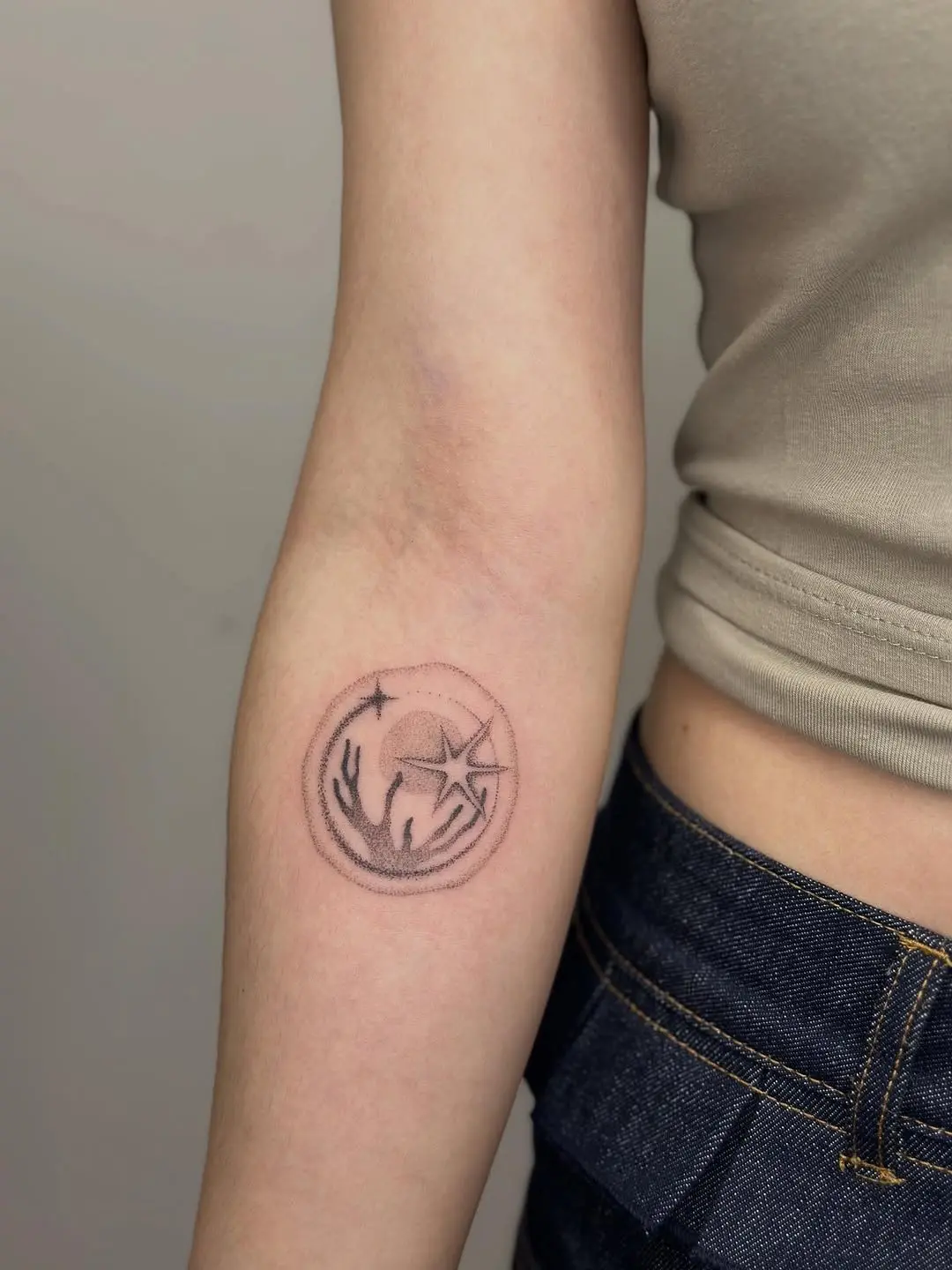 Minimalist coral reef tattoo on the arm