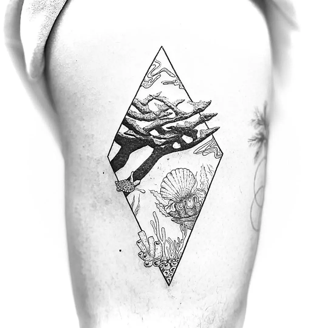 Intricate black and white coral reef tattoo design