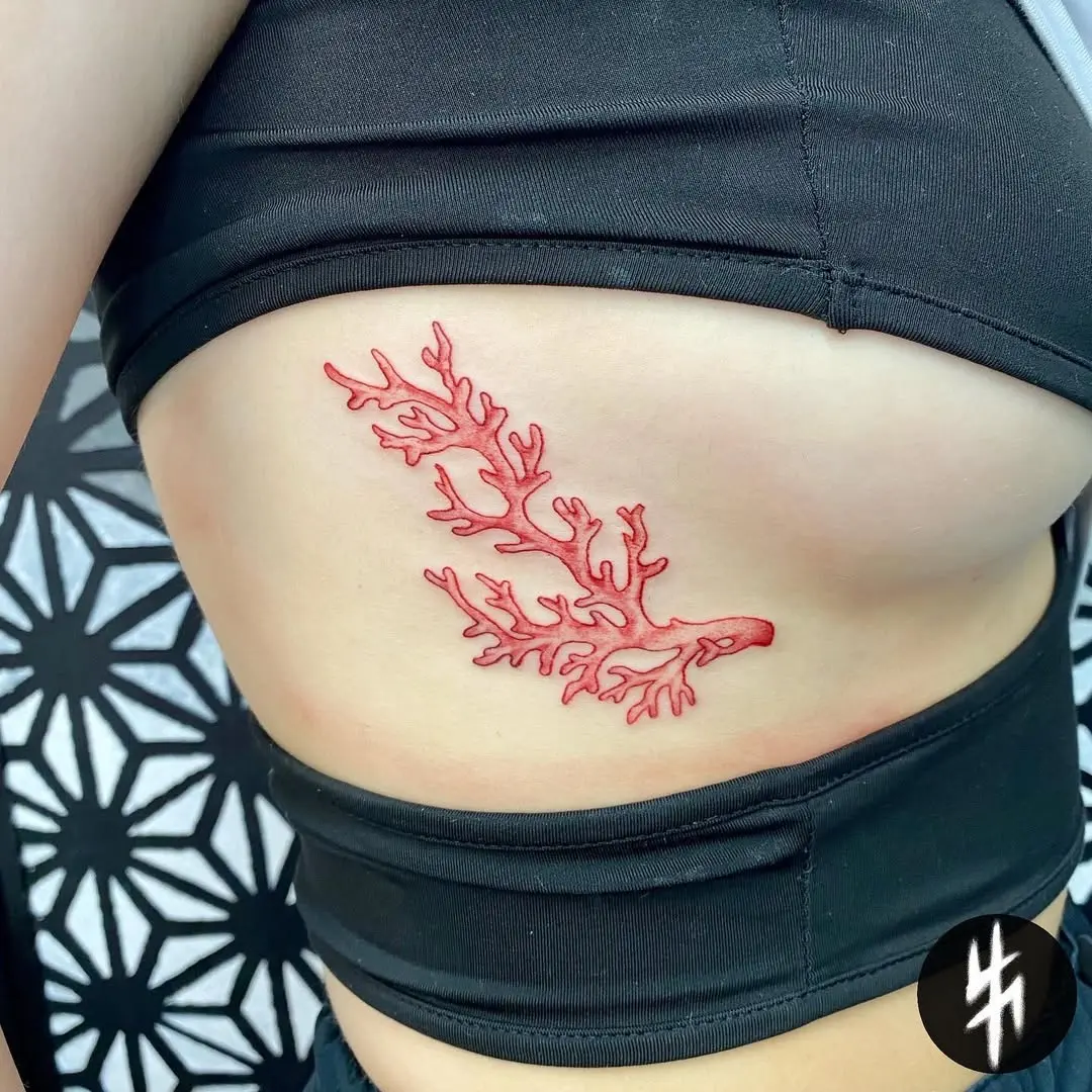 Elegant red coral tattoo on the side