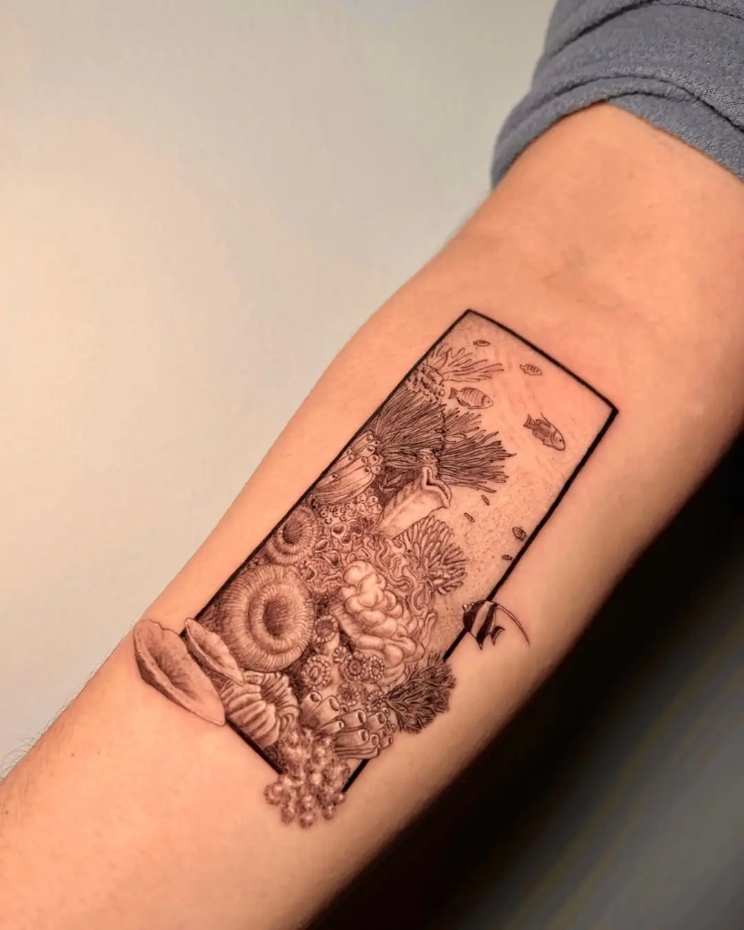 Intricate underwater scene captured in tattoo form