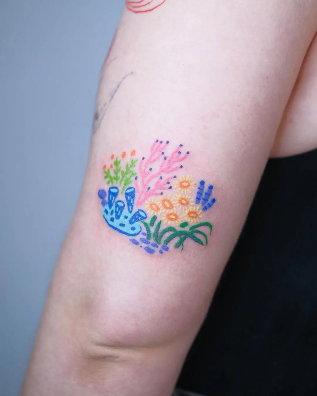 A colorful coral reef tattoo with playful elements