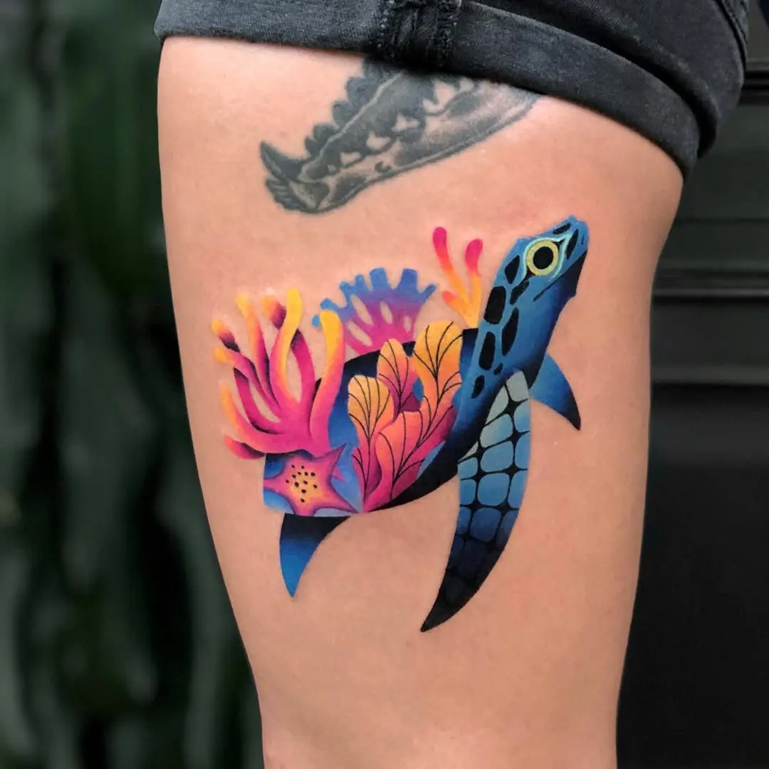 Vibrant turtle tattoo amid coral reef scene