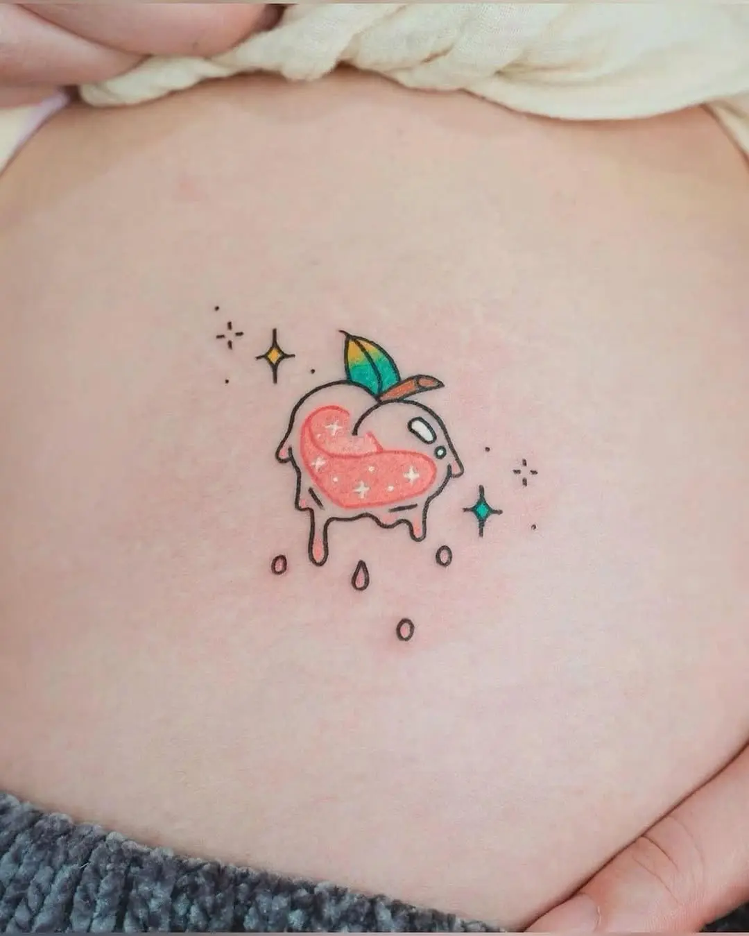 Adorable peach tattoo with a whimsical vibe